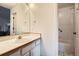 Bathroom showcasing a vanity with a mirror, white tiling, and a shower/tub combination with white tiling at 6250 Everett Ct # F, Arvada, CO 80004