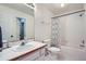 Bright bathroom features a vanity with a sink and a shower with a patterned curtain at 6250 Everett Ct # F, Arvada, CO 80004