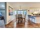 Inviting dining area with a bay window, chandelier, and access to both the kitchen and living spaces at 6250 Everett Ct # F, Arvada, CO 80004