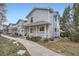 Street view of charming two-story homes with light blue siding and welcoming front porches at 6250 Everett Ct # F, Arvada, CO 80004