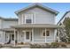 Charming two-story home with light blue siding, white trim and a welcoming front porch at 6250 Everett Ct # F, Arvada, CO 80004