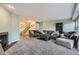 Relaxing living room featuring neutral tones, a fireplace, and a staircase leading to the upper level at 6250 Everett Ct # F, Arvada, CO 80004