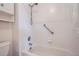 Close up of the shower/tub combination featuring white tiling and a shower head at 6250 Everett Ct # F, Arvada, CO 80004