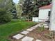 Spacious backyard includes a well-maintained lawn, stone path, and partial fencing at 4 Cherry Hills Farm Dr, Cherry Hills Village, CO 80113