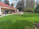 Lush backyard features a spacious lawn, outdoor dining area, and mature trees at 4 Cherry Hills Farm Dr, Cherry Hills Village, CO 80113