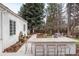 Well-appointed backyard features an outdoor kitchen, bar seating, and tranquil water feature at 4 Cherry Hills Farm Dr, Cherry Hills Village, CO 80113
