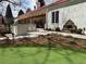 Charming backyard features an outdoor kitchen, stucco exterior, and a tranquil water fountain at 4 Cherry Hills Farm Dr, Cherry Hills Village, CO 80113