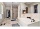 Bright bathroom features a soaking tub, glass-enclosed shower, and access to a walk-in closet at 4 Cherry Hills Farm Dr, Cherry Hills Village, CO 80113