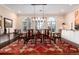 Dining room with large windows, hardwood floors, and a long dining table at 4 Cherry Hills Farm Dr, Cherry Hills Village, CO 80113
