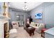 Stylish living room with fireplace, blue paneled walls, and French doors at 4 Cherry Hills Farm Dr, Cherry Hills Village, CO 80113