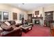 Cozy living room featuring a fireplace, leather furniture, and decorative accents at 4 Cherry Hills Farm Dr, Cherry Hills Village, CO 80113