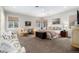 Spacious main bedroom with seating area, natural light, and ceiling fan at 4 Cherry Hills Farm Dr, Cherry Hills Village, CO 80113