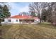 Sprawling lawn leads to a covered patio and outdoor kitchen at 4 Cherry Hills Farm Dr, Englewood, CO 80113