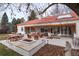 Wide backyard with a stone fire pit and covered patio at 4 Cherry Hills Farm Dr, Englewood, CO 80113