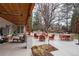 Outdoor dining and lounge area features a stone patio, shade and lovely backyard at 4 Cherry Hills Farm Dr, Englewood, CO 80113