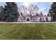 Expansive estate exhibits a circular driveway, mature landscaping, and stucco exterior with tile roof at 4 Cherry Hills Farm Dr, Englewood, CO 80113