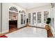 Bright hallway features large windows and doors, leading to a glimpse of the kitchen and outdoor space at 4 Cherry Hills Farm Dr, Englewood, CO 80113