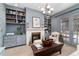 Comfortable living room featuring a fireplace, built-in bookshelves, and elegant chandelier at 4 Cherry Hills Farm Dr, Englewood, CO 80113