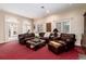 Comfortable living room featuring an oversized leather sectional, natural light, and neutral decor at 4 Cherry Hills Farm Dr, Englewood, CO 80113