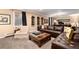 Cozy living room with dark brown leather sofa, display shelves, and natural light at 4 Cherry Hills Farm Dr, Englewood, CO 80113