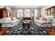 Cozy living room with floral sofas, a decorative rug, and abundant natural light from large windows at 4 Cherry Hills Farm Dr, Englewood, CO 80113