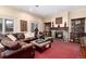 Cozy living room with large sectional, fireplace, and built-in display cabinets at 4 Cherry Hills Farm Dr, Englewood, CO 80113