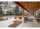 Outdoor living space featuring stone patio, fire pit, lounge seating, and mature landscaping at 4 Cherry Hills Farm Dr, Englewood, CO 80113