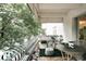 Inviting balcony with a table, chairs, and views of mature trees at 1365 Columbine St # 204, Denver, CO 80206