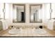 Bright bathroom with double sinks, tiled countertops, and well-lit mirrors at 1365 Columbine St # 204, Denver, CO 80206