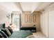 Comfortable bedroom with neutral tones, beamed ceilings, and a large window at 1365 Columbine St # 204, Denver, CO 80206