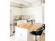 Well-lit kitchen with butcher block island, stainless steel appliances, and white cabinets at 1365 Columbine St # 204, Denver, CO 80206