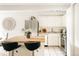 Bright kitchen featuring butcher block island with seating, stainless steel refrigerator, and white cabinetry at 1365 Columbine St # 204, Denver, CO 80206