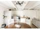 Bright kitchen with white cabinets, stainless steel appliances, and modern lighting at 1365 Columbine St # 204, Denver, CO 80206