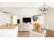 Bright, open living space with views of the kitchen, dining area, and main living room with TV at 1365 Columbine St # 204, Denver, CO 80206