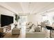 Open-concept living room with large sofa, TV, and sliding glass door to balcony, perfect for relaxing at 1365 Columbine St # 204, Denver, CO 80206