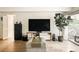 Cozy living room featuring a large TV, modern console, and access to an outdoor balcony at 1365 Columbine St # 204, Denver, CO 80206