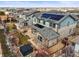 Aerial view of homes with solar panels, fenced yard, and stone patio at 7875 S Grand Baker St, Aurora, CO 80016