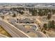 Aerial view of community pool and clubhouse surrounded by natural landscape, homes, and winding roads at 7875 S Grand Baker St, Aurora, CO 80016