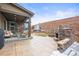 Covered back patio with fireplace and outdoor seating area, perfect for enjoying the backyard at 7875 S Grand Baker St, Aurora, CO 80016