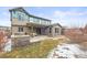 Exterior backyard with a stone patio, outdoor seating, and a well-maintained lawn perfect for outdoor entertainment at 7875 S Grand Baker St, Aurora, CO 80016