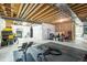 Unfinished basement space with exposed beams, workout equipment, and potential for customization at 7875 S Grand Baker St, Aurora, CO 80016