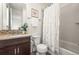 Modern bathroom with updated vanity, mosaic tile backsplash and shower with curtain at 7875 S Grand Baker St, Aurora, CO 80016