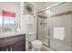 Bathroom with glass-enclosed shower, stylish tile accents, modern fixtures, and a dark wood vanity at 7875 S Grand Baker St, Aurora, CO 80016