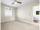 Bedroom with carpet, large window with shutters, and access to another room at 7875 S Grand Baker St, Aurora, CO 80016