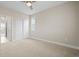 Bright bedroom with plush carpeting, closet space, ceiling fan, and a window with lots of natural light at 7875 S Grand Baker St, Aurora, CO 80016