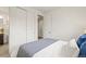 Bright bedroom with white walls, plush bedding, and ample closet space at 7875 S Grand Baker St, Aurora, CO 80016