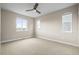 Spacious bedroom featuring a ceiling fan and large windows offering natural light at 7875 S Grand Baker St, Aurora, CO 80016