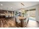 Open concept dining area with dark wood floors, a modern chandelier, and access to the kitchen at 7875 S Grand Baker St, Aurora, CO 80016