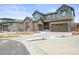 Beautiful two-story home with stone accents, a three-car garage, and a well-manicured lawn at 7875 S Grand Baker St, Aurora, CO 80016