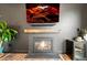 Living room fireplace with modern tile surround, rustic mantel, and large screen television on the wall at 7875 S Grand Baker St, Aurora, CO 80016